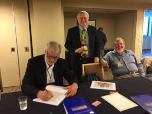 Frank signs Bob Leonard's book